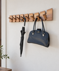 Minimalist wooden coat rack crafted from oiled natural walnut