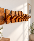 Artisan crafted walnut entryway organizer with integrated wooden coat hooks